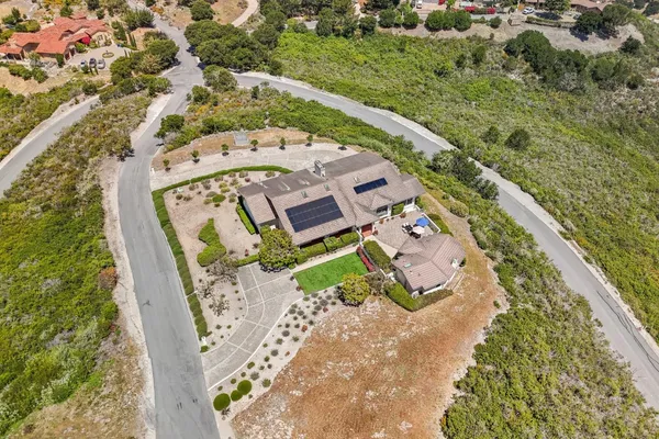 an aerial view of a swimming pool with a yard