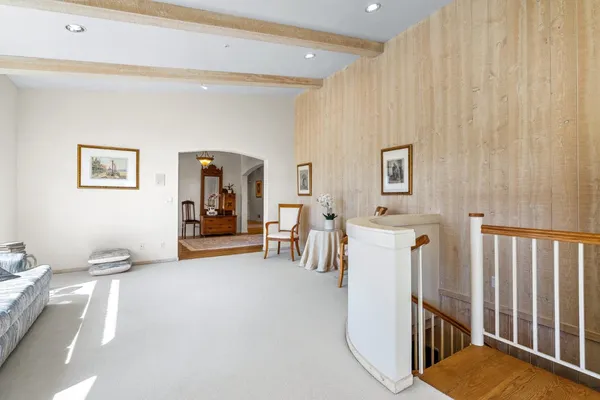a view of a livingroom with furniture and staircase