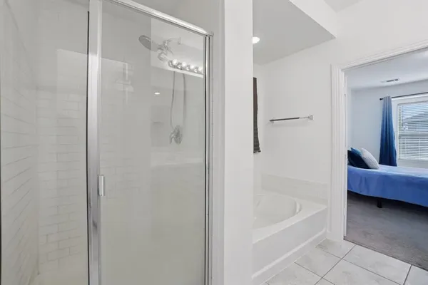 a bathroom with a tub shower and sink