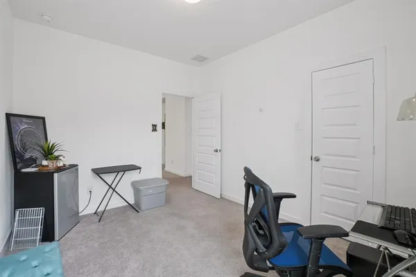 a view of a livingroom with chairs and chair
