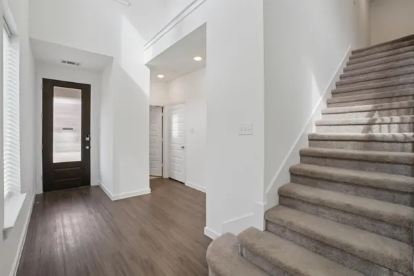 a view of an entryway with wooden floor