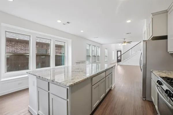 a kitchen with counter top space and windows