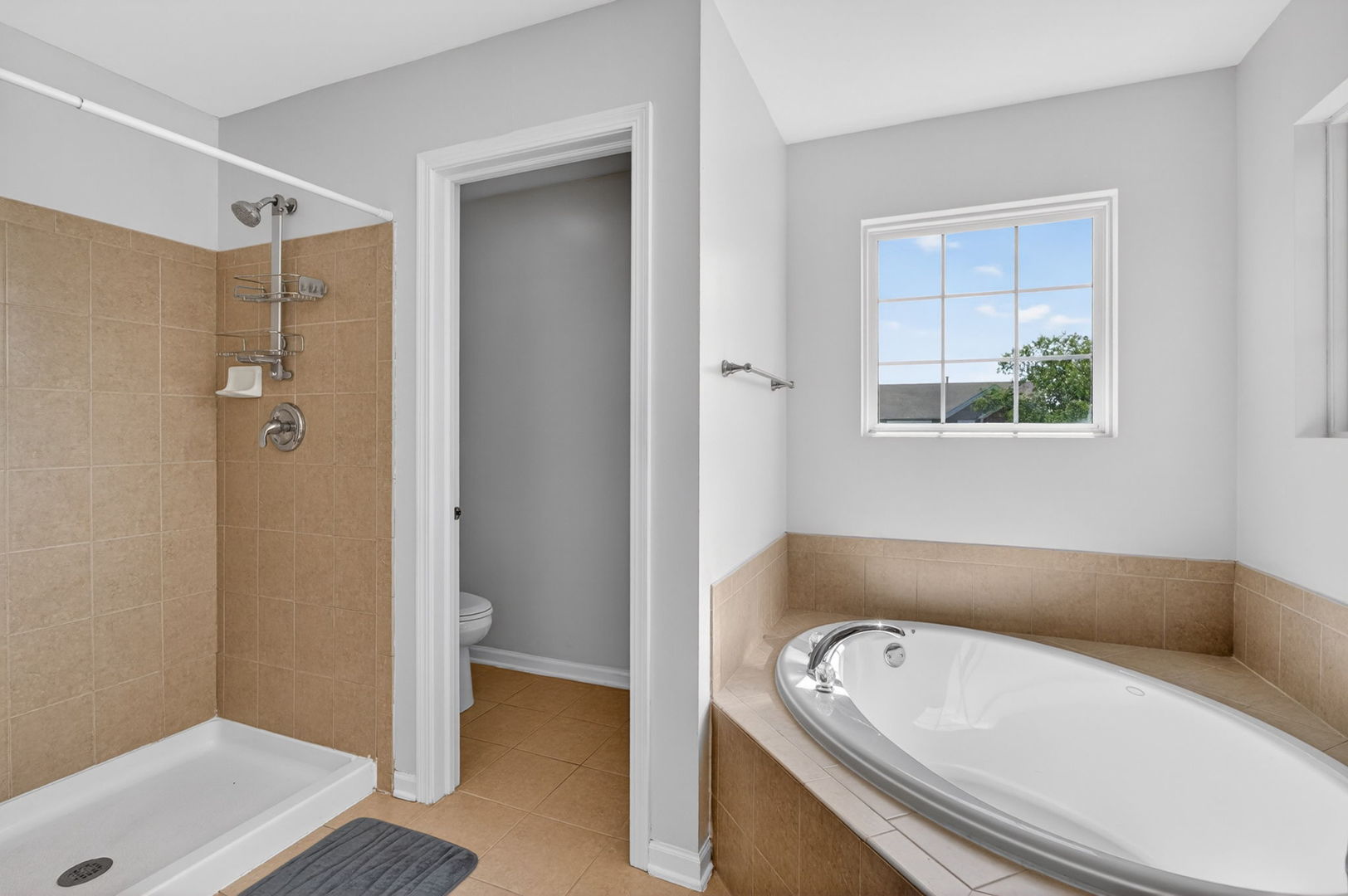 25204 Spring Street Manhattan, IL 60442 - Photo 17 of 34 a bathroom with a tub a sink and a window