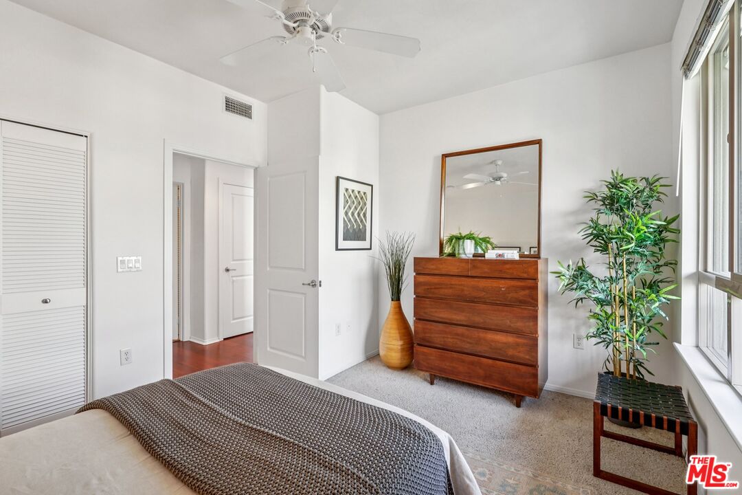 100 South Alameda Street, Unit 477 Los Angeles, CA 90012 - Photo 11 of 24 a bedroom with a bed and a couch