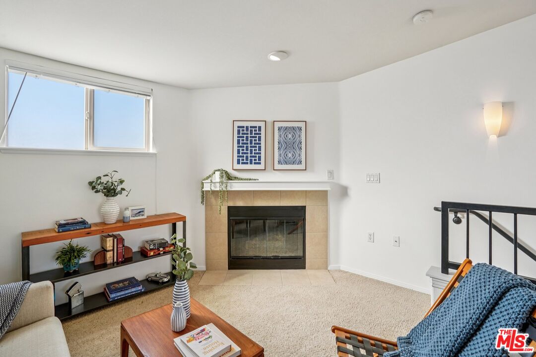 100 South Alameda Street, Unit 477 Los Angeles, CA 90012 - Photo 14 of 24 a living room with furniture and a fireplace