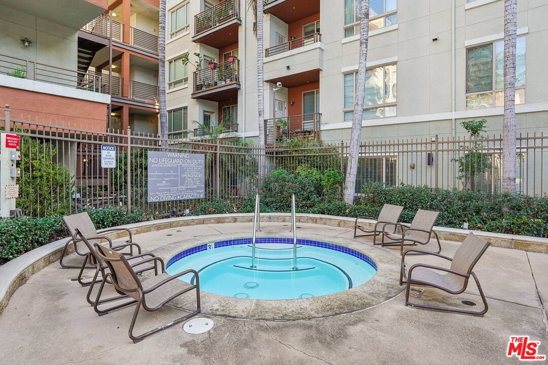 100 South Alameda Street, Unit 477 Los Angeles, CA 90012 - Photo 20 of 24 a view of a building with a swimming pool and sitting area