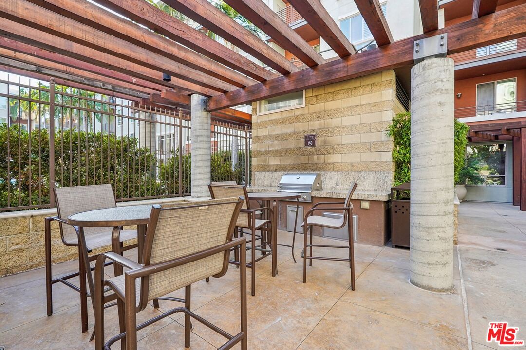 100 South Alameda Street, Unit 477 Los Angeles, CA 90012 - Photo 21 of 24 a view of a patio with a table and chairs and potted plants