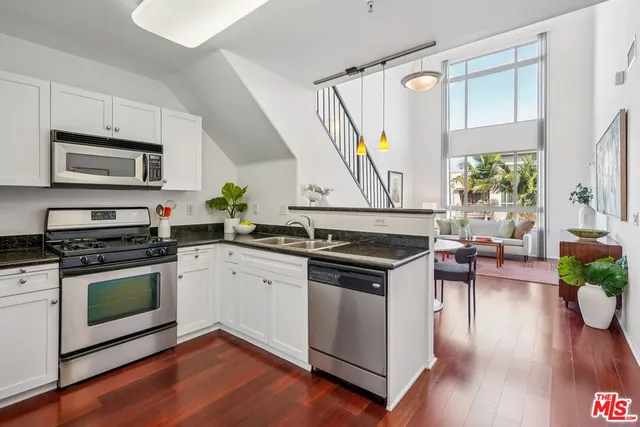 a kitchen with a stove a sink and a microwave