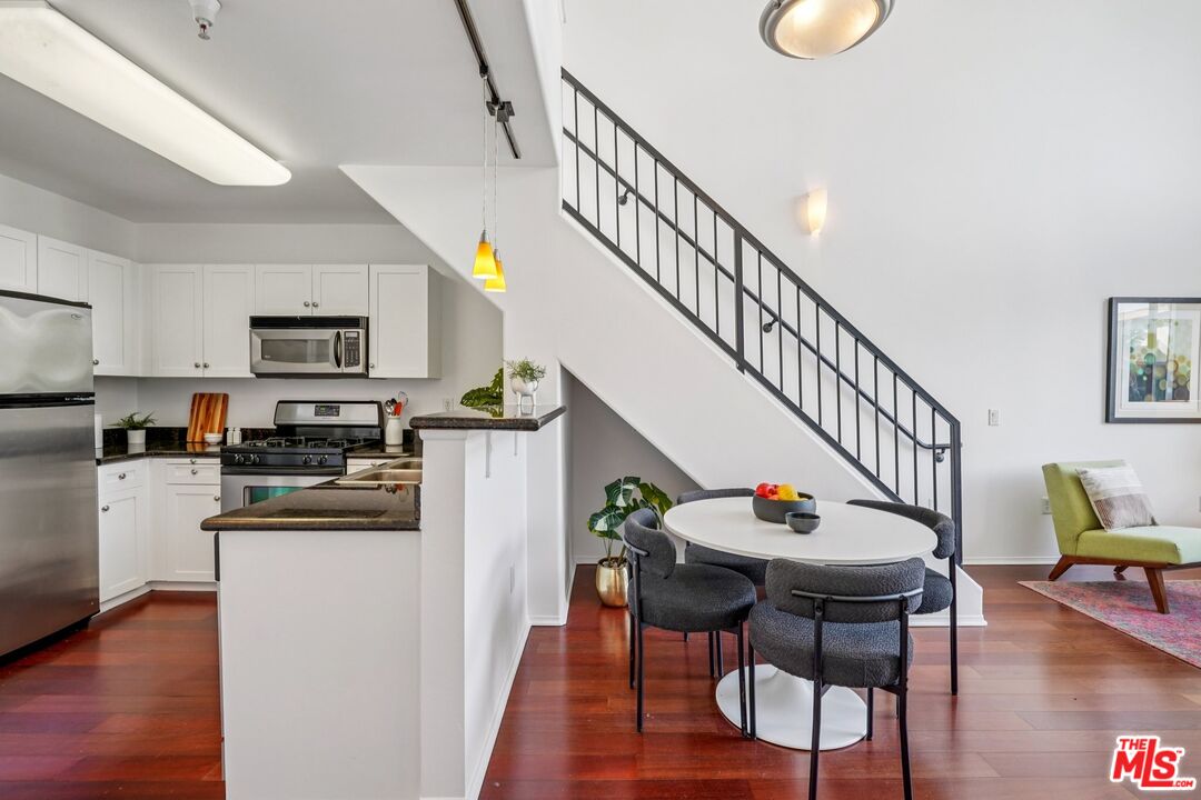 100 South Alameda Street, Unit 477 Los Angeles, CA 90012 - Photo 5 of 24 a dining room with wooden floor and a dining table