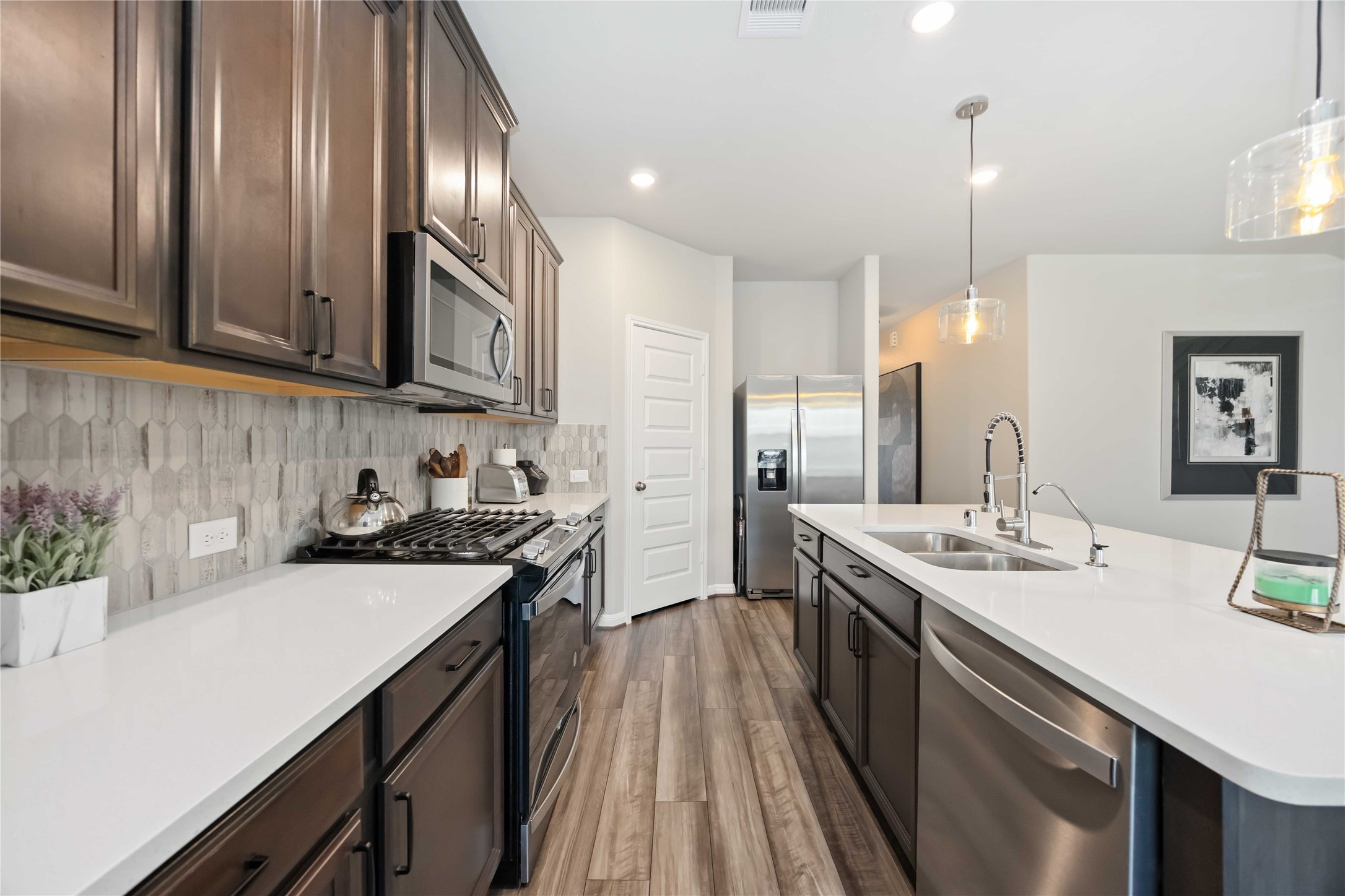 6910 Lebec Drive Rosharon, TX 77583 - Photo 13 of 26 a kitchen with a sink stove and cabinets