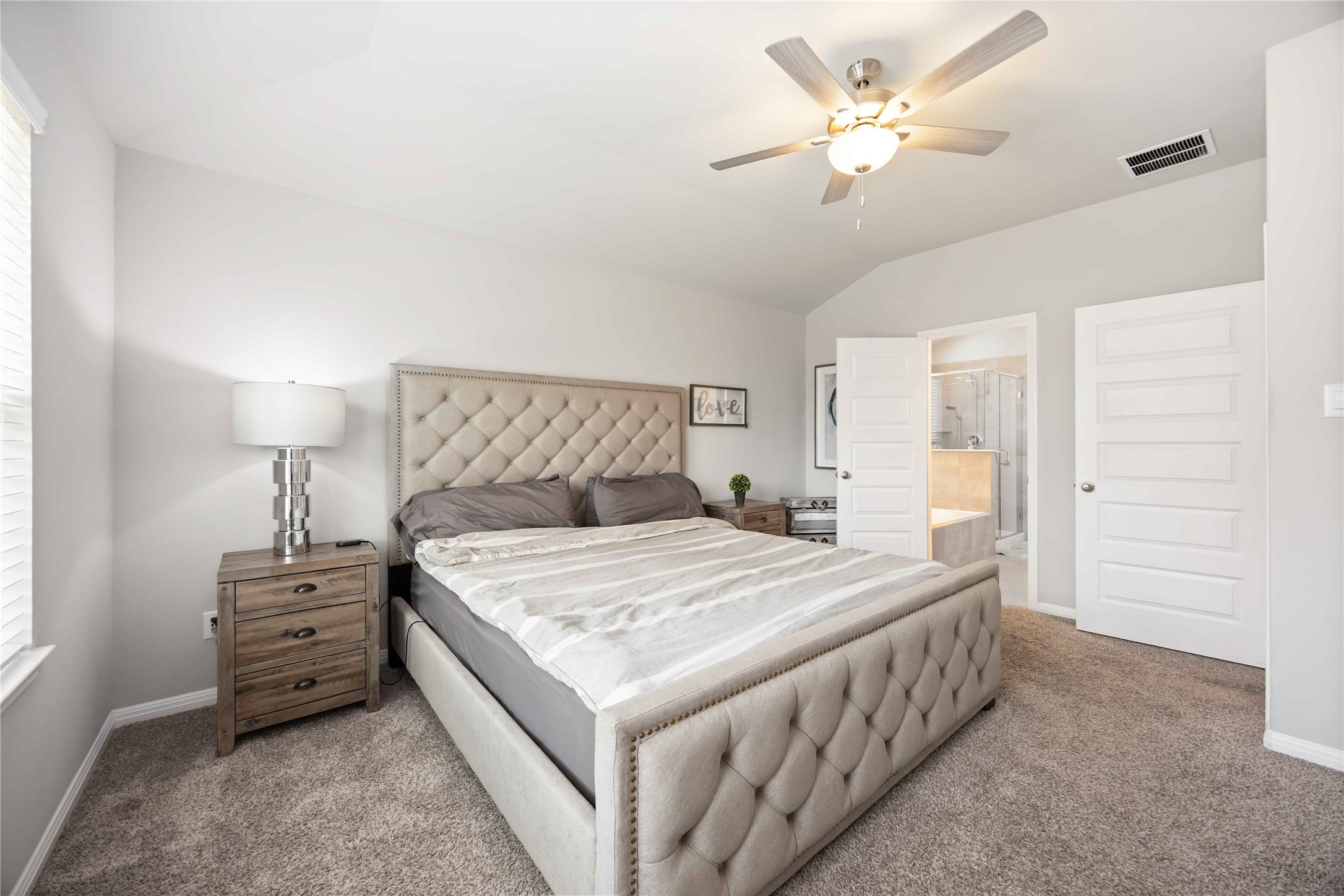 6910 Lebec Drive Rosharon, TX 77583 - Photo 18 of 26 a bedroom with a bed a chandelier and a closet