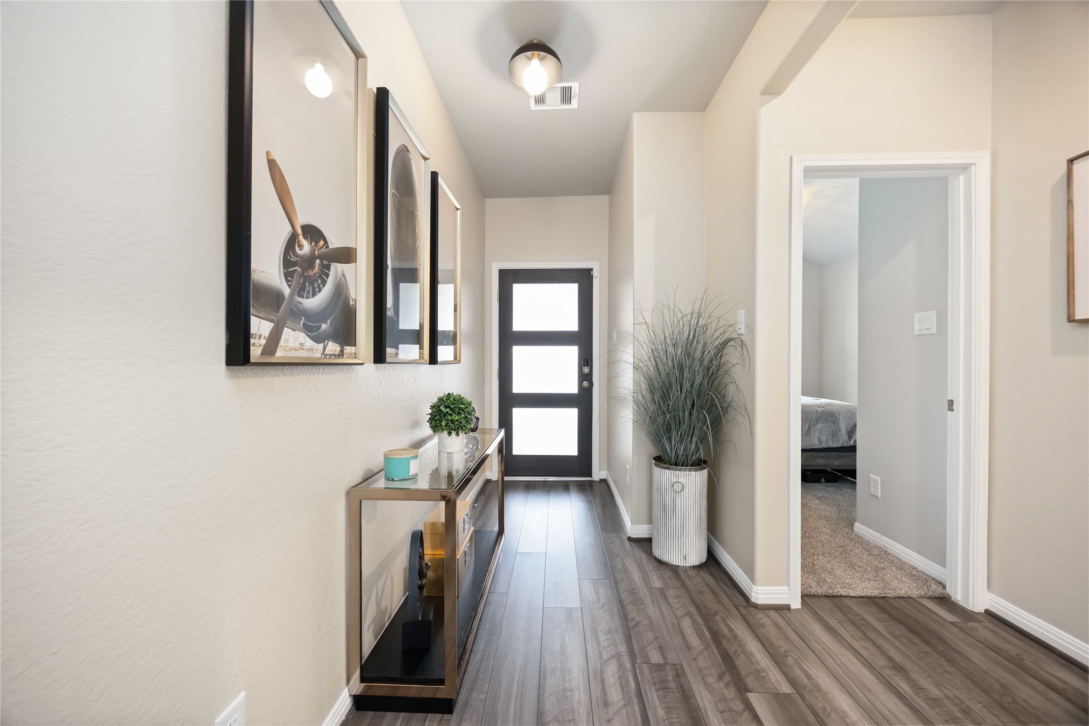 6910 Lebec Drive Rosharon, TX 77583 - Photo 3 of 26 a view of a hallway with wooden floor and stairs