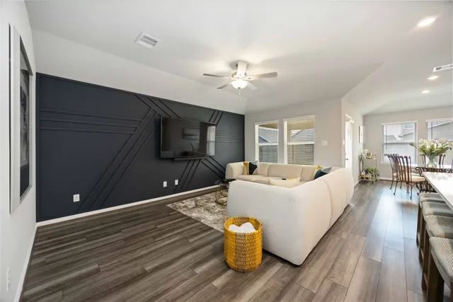 a living room with furniture and kitchen view