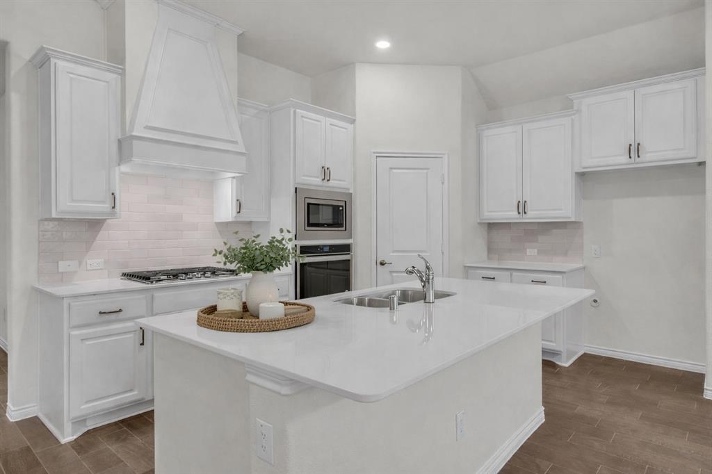 3106 Maverick Drive Forney, TX 75126 - Photo 10 of 32 a kitchen with appliances a sink and cabinets