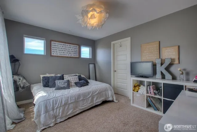 a bedroom with a bed and a chandelier