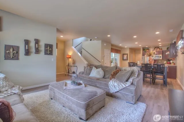 a living room with furniture and kitchen view