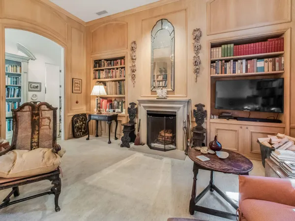 a living room with furniture fireplace and baby crib