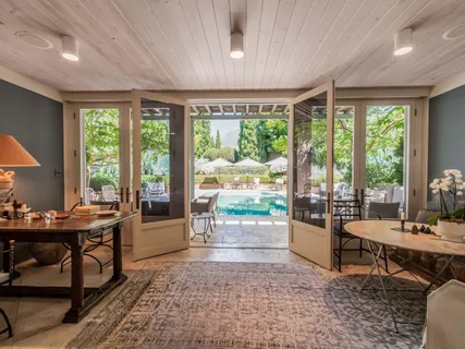 a view of a house with swimming pool and sitting area
