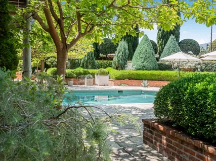 an aerial view of a house with garden space and street view