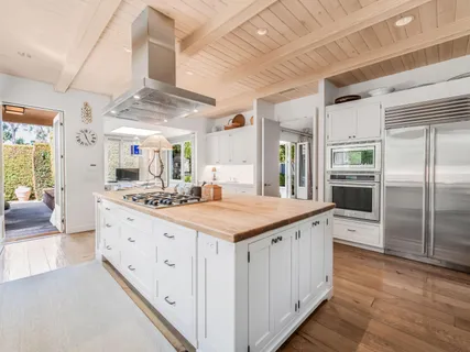 a kitchen with stainless steel appliances a sink stove and cabinets