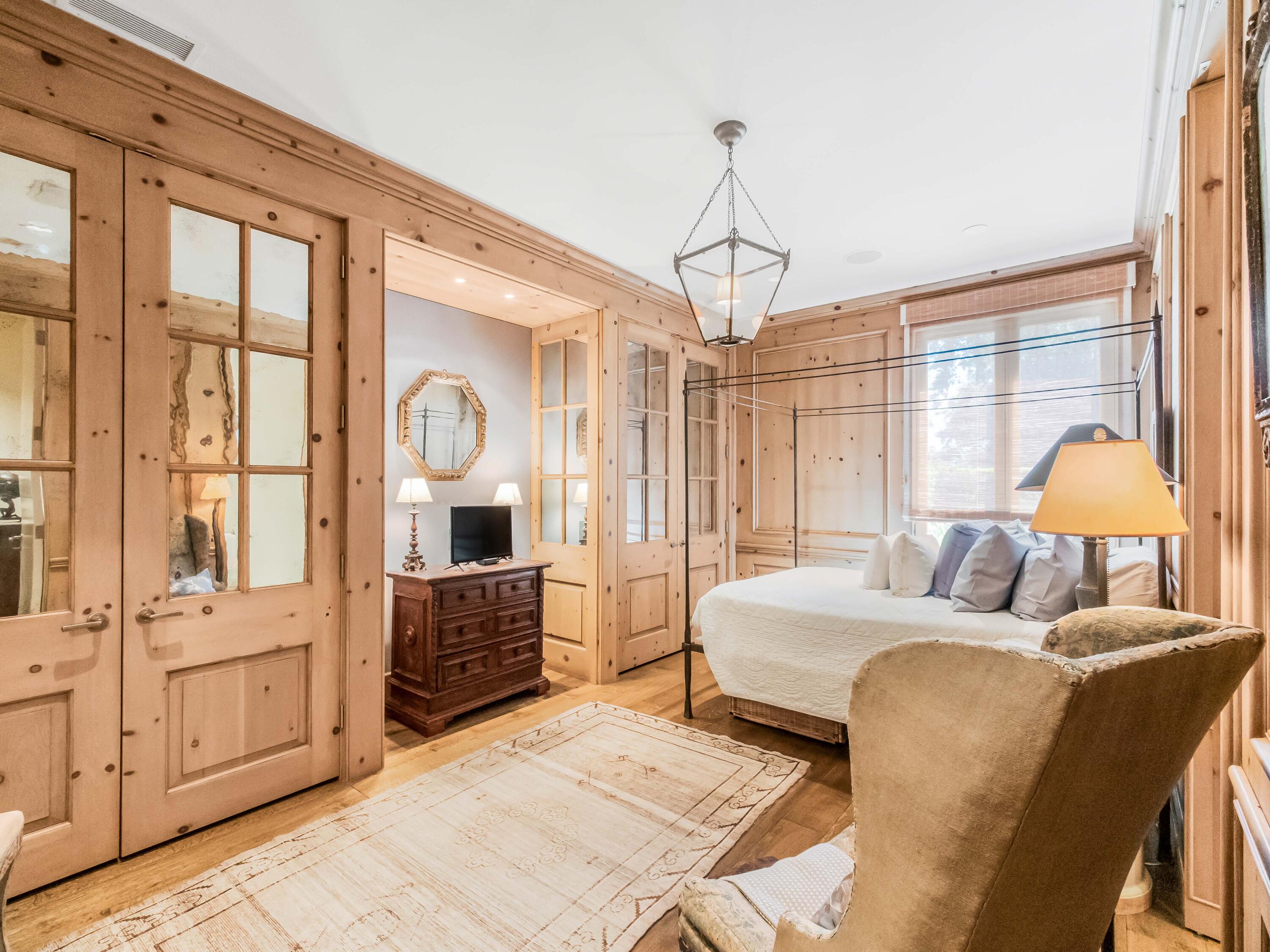 2072 China Flat Road Montecito, CA 93108 - Photo 35 of 41 a bedroom with a bed chandelier and a window