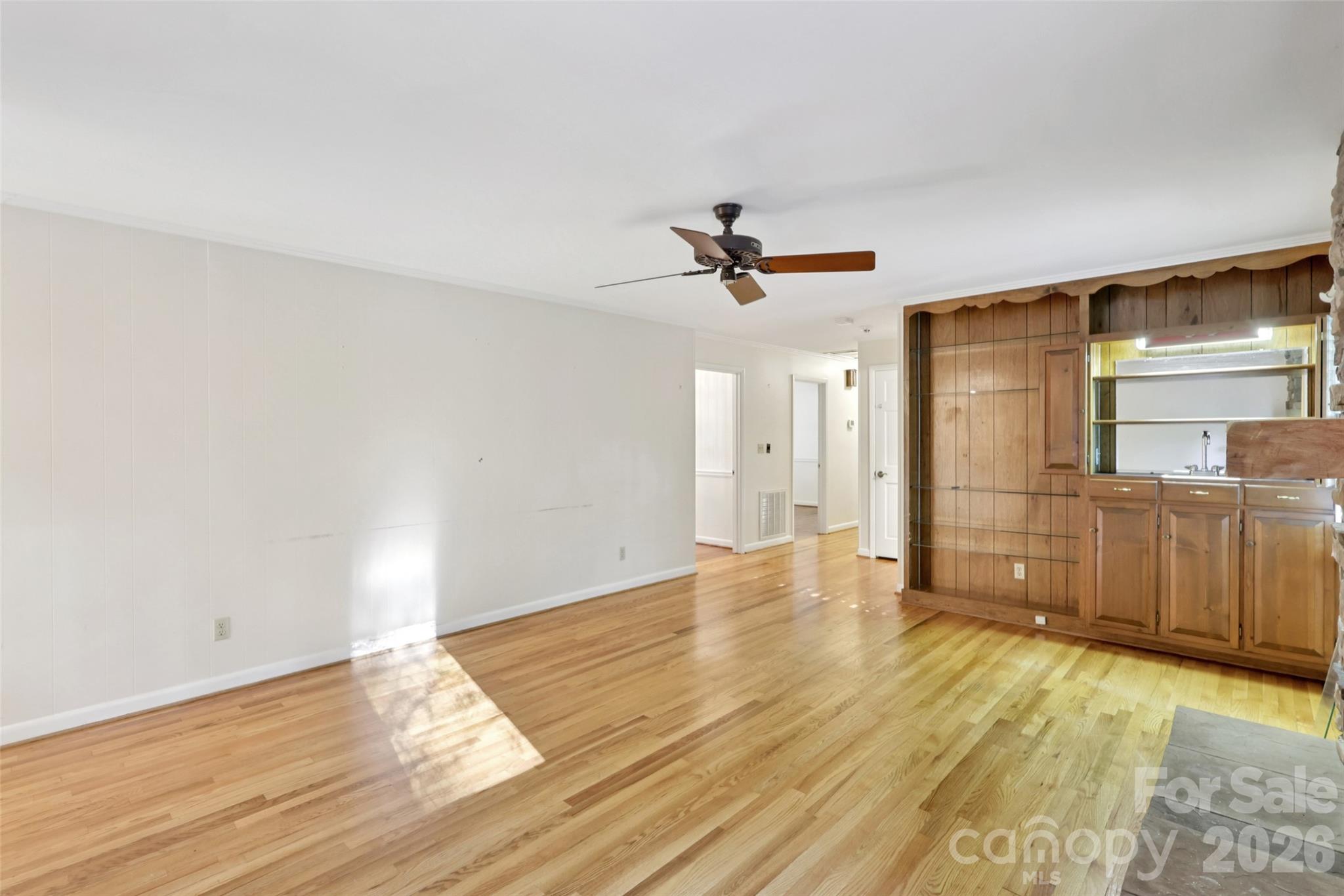 1002 Ridge Street Albemarle, NC 28001 - Photo 12 of 45 a view of a livingroom with wooden floor and a ceiling fan