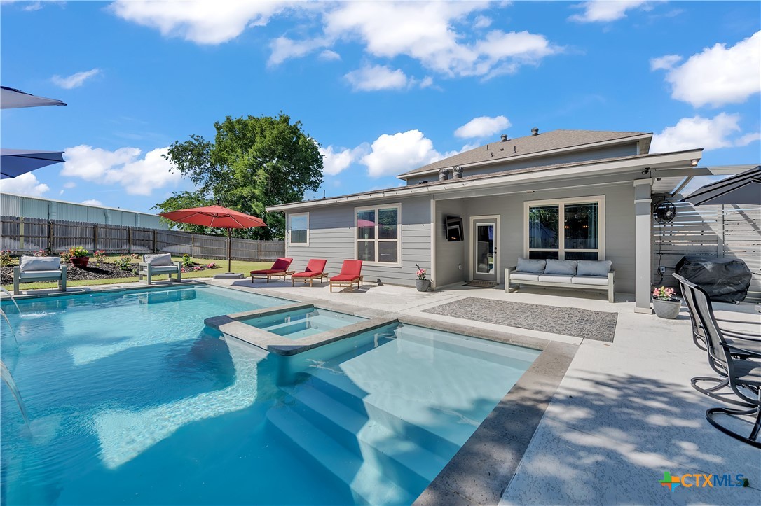 5010 Fallen Tree Drive Temple, TX 76502 - Photo 2 of 40 a view of a swimming pool with outdoor seating and a patio