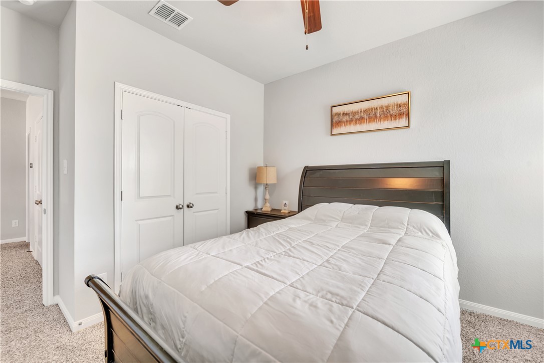 5010 Fallen Tree Drive Temple, TX 76502 - Photo 24 of 39 a bedroom with a bed and a lamp on the dresser