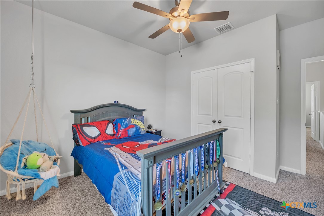 5010 Fallen Tree Drive Temple, TX 76502 - Photo 27 of 40 a bedroom with baby crib and a chandelier