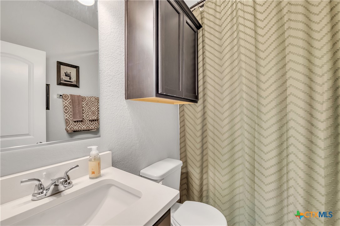 5010 Fallen Tree Drive Temple, TX 76502 - Photo 30 of 39 a bathroom with a sink a toilet and a mirror