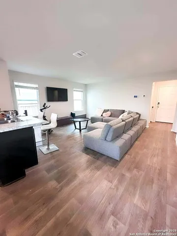 a living room with furniture window and a flat screen tv