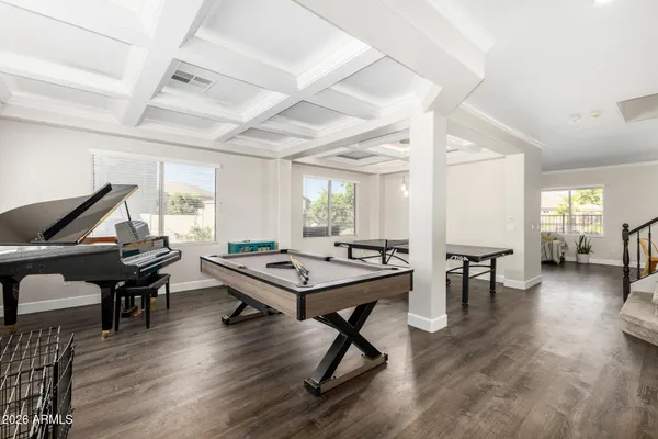 a living room with furniture flat screen tv and large window