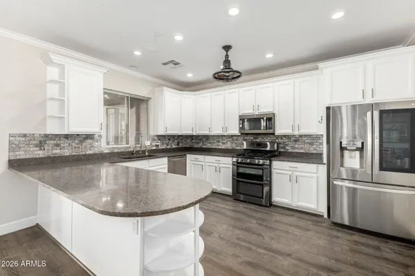 a living room with furniture and a ceiling fan