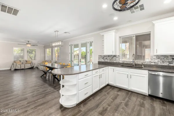a spacious bedroom with a bed and a chandelier