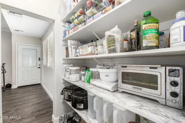 a bedroom with a bed and dresser with mirror