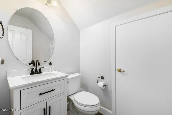 a spacious bathroom with a granite countertop sink and a mirror