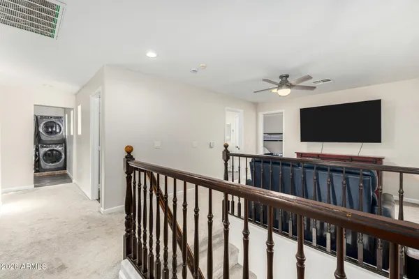 a spacious bedroom with a bed and a chandelier