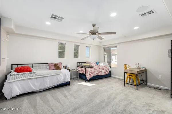 a bedroom with a bed and a chandelier