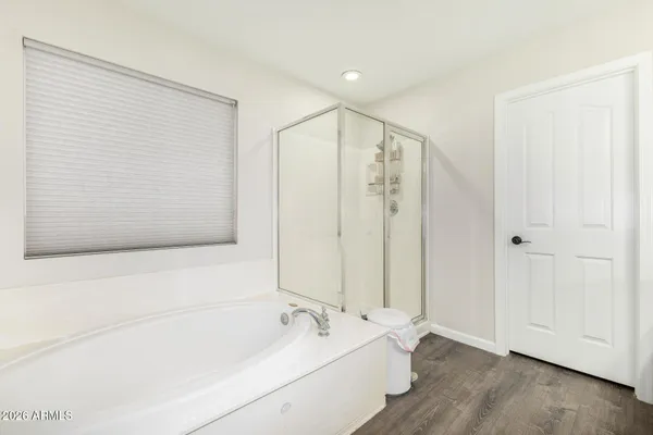 a bedroom with a bed and a ceiling fan