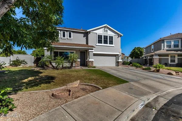 a front view of a house with a yard and garage