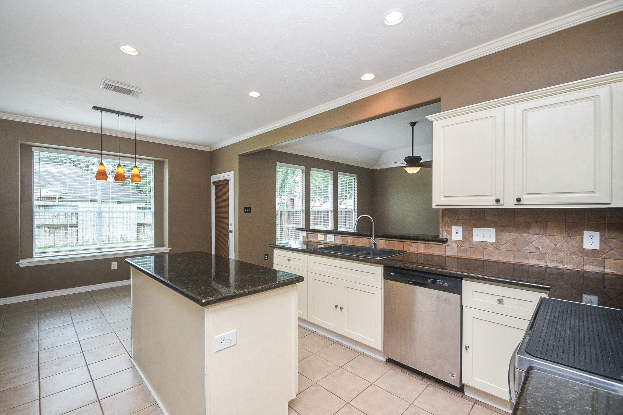 5602 Walkabout Way Katy, TX 77450 - Photo 9 of 33 a kitchen with granite countertop white cabinets white appliances a sink and a window