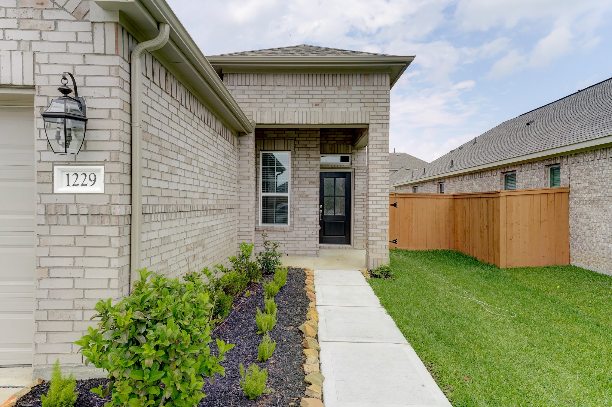 1229 Red Hills Drive Rosharon, TX 77583 - Photo 2 of 29 a front view of a house with garden
