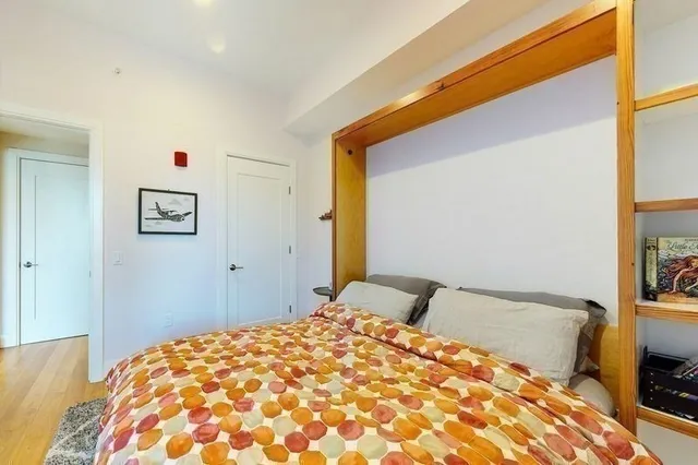 a bedroom with a bed and a dresser