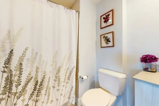 a bathroom with a toilet a sink and a mirror