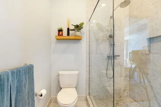 a en suite bathroom with a granite countertop sink and a mirror
