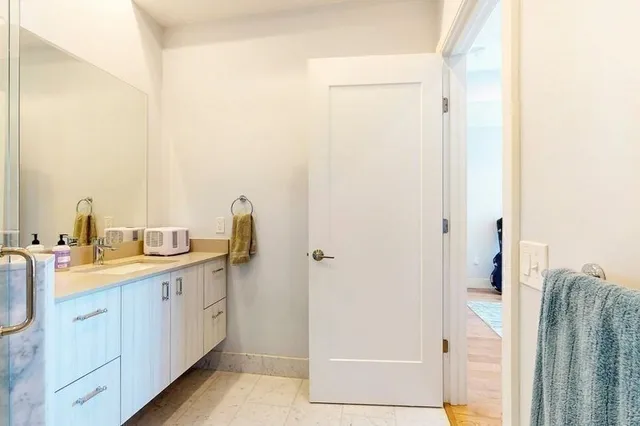 a view of walk in closet with clothes