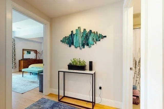 a bedroom with a bed and a painting on the wall