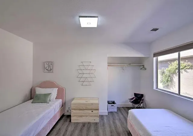 a bedroom with a bed and a window