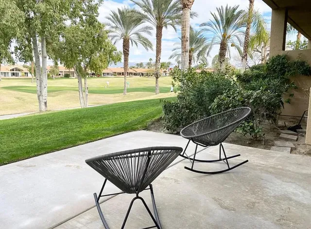 a view of a swimming pool and lounge chairs