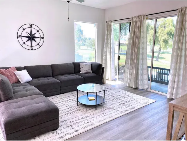 a living room with furniture or couch and a large window